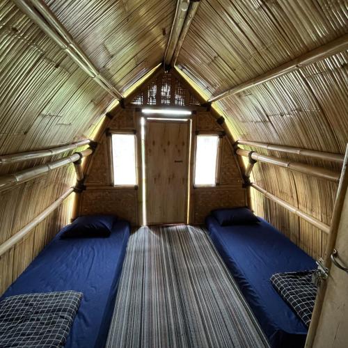 a room with two beds in a small room at Homestay Syariah Tipe C Kadudampit Sukabumi in Citamiang