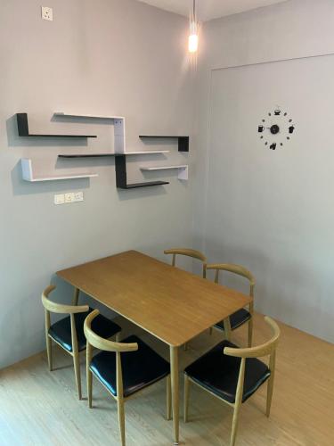 a wooden table and chairs in a room at Sandakan Js homestay in Sandakan