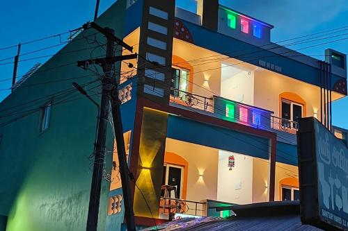 a building with colorful lights on the side of it at Harkesh Residency in Puducherry Airpoert