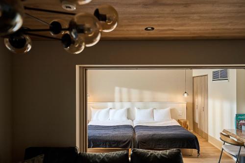a bedroom with a bed with a large mirror at R.Kamakura in Kamakura