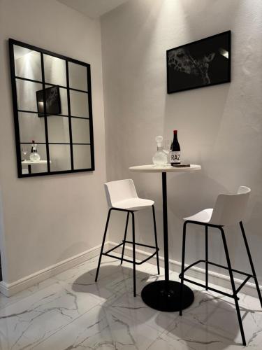a table and two chairs in a room with a mirror at Luxurious Apartment in Cape Town