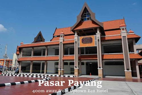 a large building with a sign in front of it at Uptown Eco Hotel in Kuala Terengganu