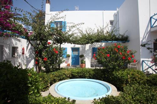 a pool in the yard of a house with flowers at Blue Sky in Galissas