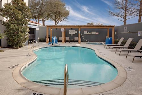 a swimming pool with lounge chairs around it at Courtyard Fort Worth I-30 West Near NAS JRB in Fort Worth