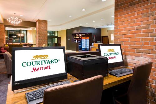 two laptop computers sitting on a table in a restaurant at Courtyard by Marriott Little Rock Downtown in Little Rock