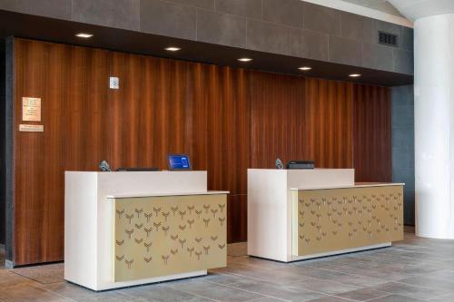 a lobby with two podiums in front of a wooden wall at Courtyard by Marriott Waterloo Cedar Falls in Waterloo