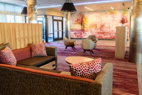 a lobby with couches and chairs and a table at Courtyard by Marriott Lake Jackson in Lake Jackson