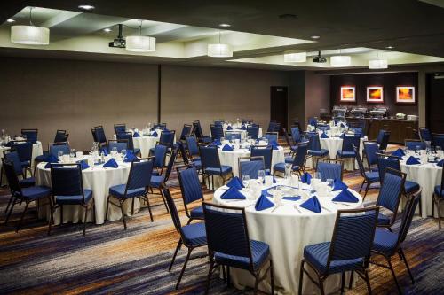 a banquet hall with tables and chairs with white table settings at Courtyard by Marriott Walla Walla in Walla Walla