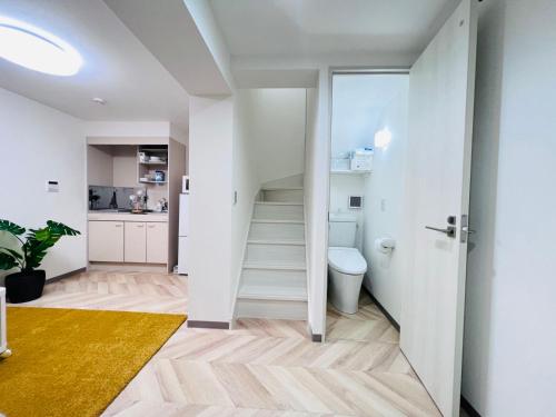 a room with a staircase and a toilet at Sugamo 1F-TS0334 in Tokyo