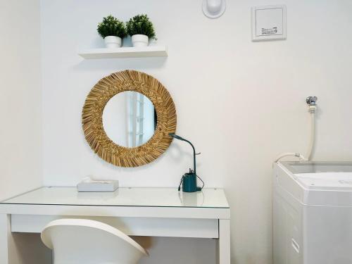 a white bathroom with a mirror and a sink at Sugamo 1F-TS0334 in Tokyo