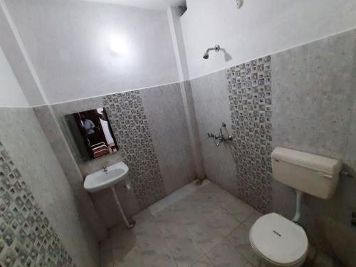 a bathroom with a toilet and a sink at Janardan Homestay Lucknow in Lucknow