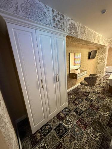 a large white cabinet in a room with a floor at AL MARYAM HoteL in Samarkand