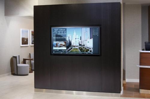 a flat screen tv on a wall in a room at Courtyard by Marriott Dallas Plano/The Colony in The Colony