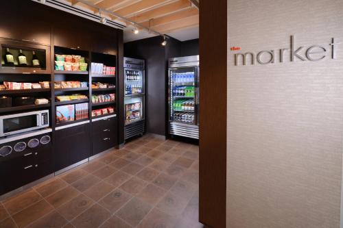 a grocery store aisle with two refrigerators and a m maker refrigerator at Courtyard by Marriott Dallas Plano/The Colony in The Colony