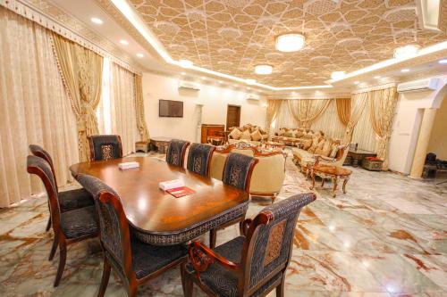 a large room with a table and chairs and a dining room at Al Bada Hotel and Resort in Al Ain