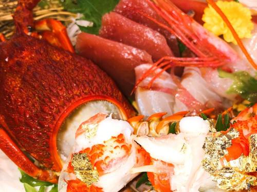 a plate of food with shrimp and other foods at Simamegurinoyado Sakai in Ishinomaki