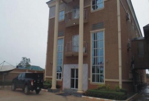 a truck parked in front of a large building at Sheriffyt Royale Hotel Suites - Deluxe in Ikorodu