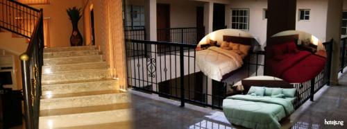 a balcony with two chairs and a couch on it at Orchard Hotel - Standard in Ibadan