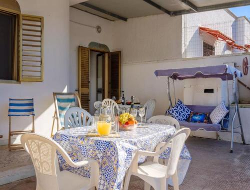 a table and chairs with a table and a bed at Tramontana Villa 30 Meters From the Beach no4687 in Torre Specchia Ruggeri