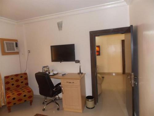 a room with a desk with a computer and a chair at Ayalla Hotels now Elomas Hotel-Executive in Abuja