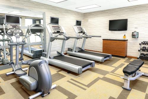 a gym with cardio equipment and a flat screen tv at Courtyard Bethlehem Lehigh Valley/I-78 in Bethlehem