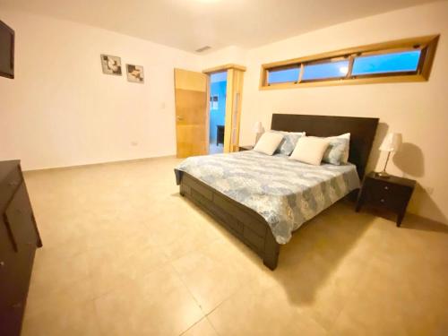 a large bedroom with a bed and a window at Marbella 2bedroom Beachfrom Apt in San Pedro de Macorís