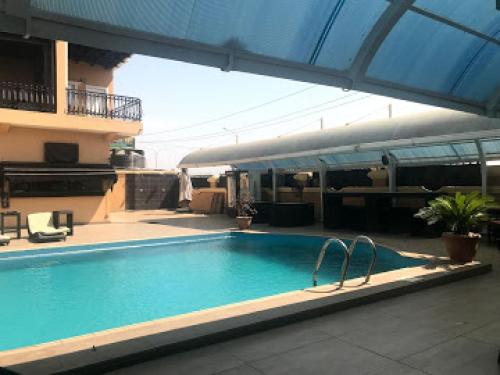 a large swimming pool with two metal rails in a building at Nippon Grand Hotels - Grand Suite in Jabi