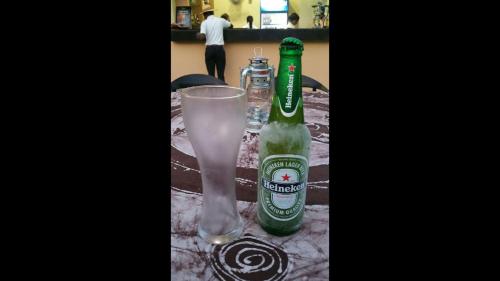 a table with a bottle of beer and a glass at Nippon Grand Hotels - Grand Suite in Jabi