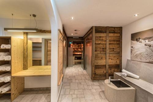 a kitchen with wooden cabinets and a sink in a room at Apart Forum in Ischgl