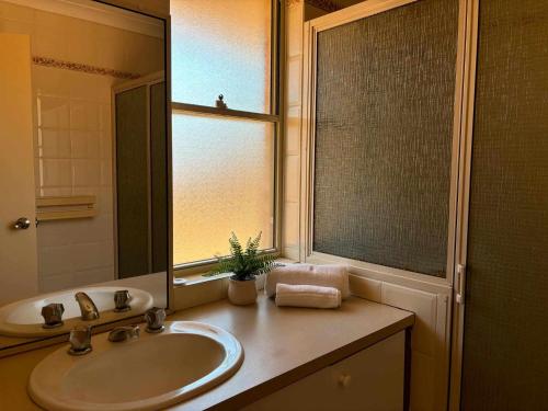 une salle de bain avec un lavabo et un miroir dans l'établissement Kalbarri Holiday Villas B, à Kalbarri