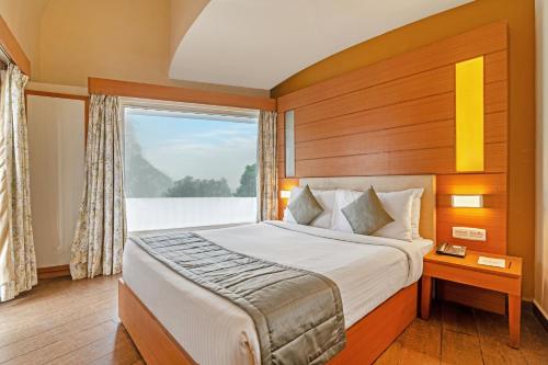 Ein Bett oder Betten in einem Zimmer der Unterkunft Sterling Kodai Valley