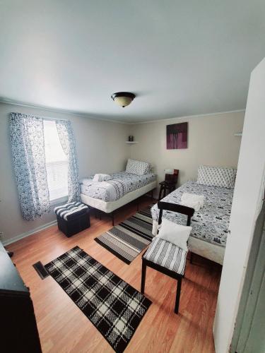 a bedroom with two beds and a table and a chair at Black-white Rm By Yale U in New Haven