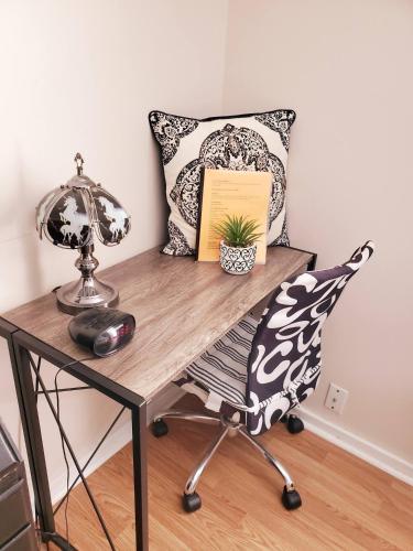 a desk with a chair with a lamp and a pillow at Black-white Rm By Yale U in New Haven