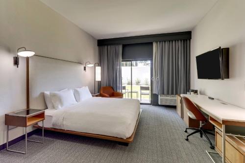 a hotel room with a bed and a desk at Courtyard Lexington South/Hamburg Place in Lexington