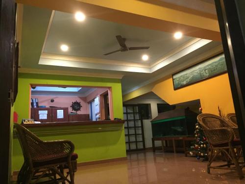 a living room with a pool table and chairs at Hotel Thushara in Kovalam