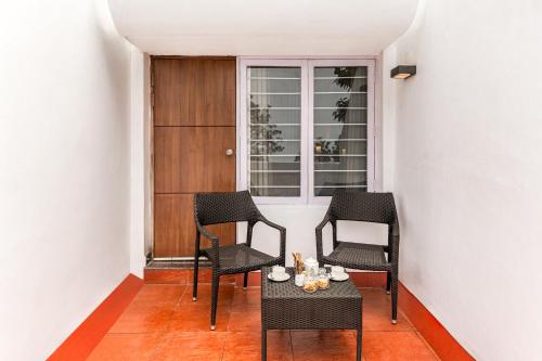 a room with three chairs and a table and a window at Sterling Yercaud in Yercaud