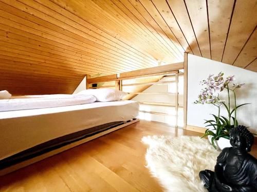 a bedroom with a bed in a wooden wall at Einzigartige Schone Altbau- Wohnung Im Zentrum in St. Gallen