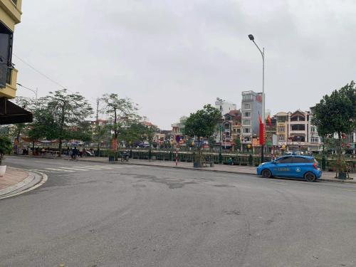 a blue car parked on the side of a street at Homestay Cobalt House in Hai Phong
