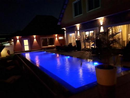 a swimming pool at night with blue lights at Leola Hotel-standard in Ikeja