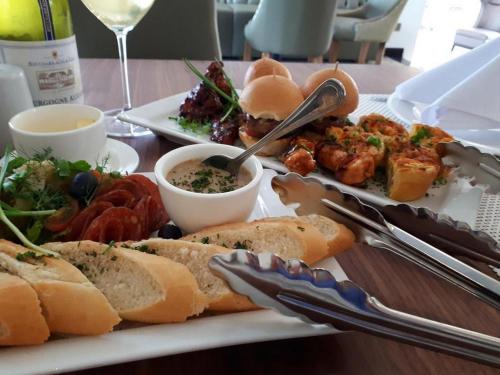 a plate of food with bread and other foods on a table at Leola Hotel-standard in Ikeja