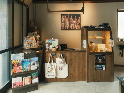a store with a counter with books and bags at Negura in Ujimi
