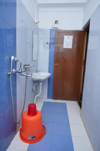 a bathroom with a toilet and a sink and a shower at Sea Pearl Homestay in Port Blair