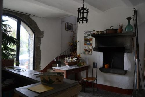 a living room with a table and a fireplace at Two-room charming apartment in Tuscan rustic style in La Lama