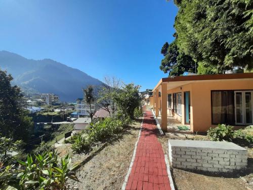 a red brick walkway next to a house at Janardan Resort Pangot, Nainital in Nainital