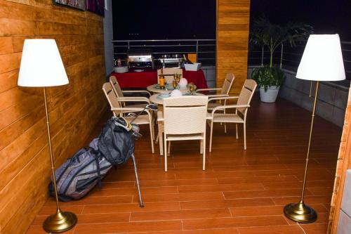 a dining room with two lamps and a table with chairs at Limewood Hotel - Classic in Port Harcourt