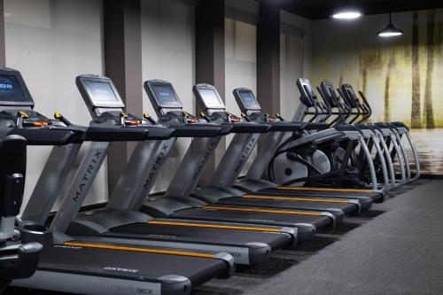 a row of tread machines in a gym at Courtyard Kansas City Olathe in Olathe