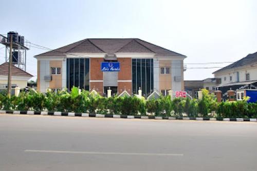 a building with a sign in front of a street at Lois Hotel - Diamond in Jabi