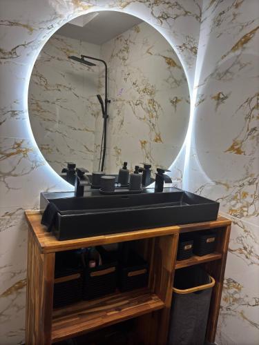 une salle de bain avec un lavabo noir et un miroir dans l'établissement Maison Canet Confort Moderne Prs De La Plage, à Canet