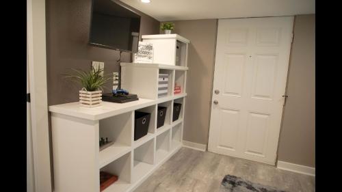 a room with a white book shelf and a white door at Family Home with Private Pool Yard Only 24 Mi to Disney in Saint Cloud