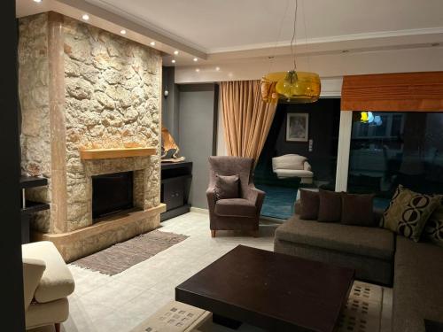 a living room with a couch and a fireplace at Luxury Heaven farm one in Kastoria